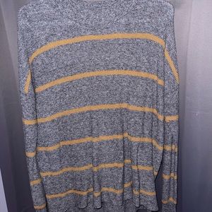 Woman’s brown and gray stripped sweater